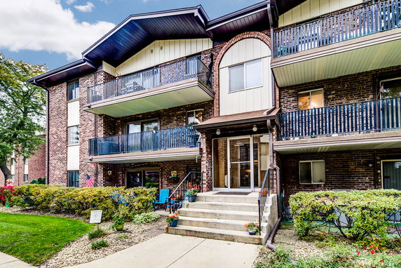 Front view of a multi-story residential building with balconies.