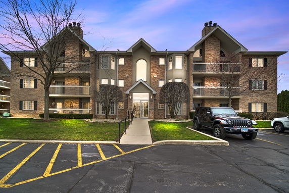 Front view of a multi-story residential building with balconies.