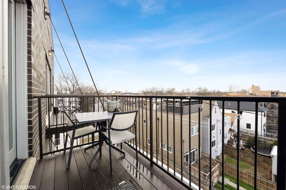 View from a balcony overlooking a residential area with multiple houses.