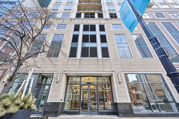Front view of a multi-story building with large windows and entrance.
