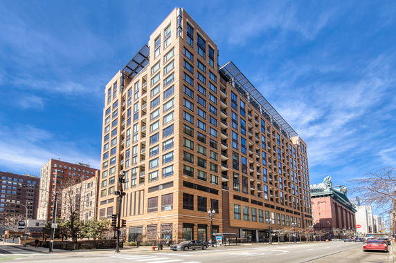 Front view of a multi-story residential building with numerous windows.