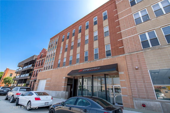 Front view of a multi-story commercial building with a brick facade.