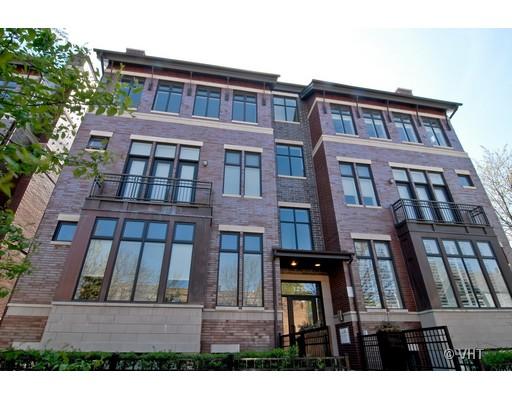 Front view of a multi-story building with large windows and balconies.