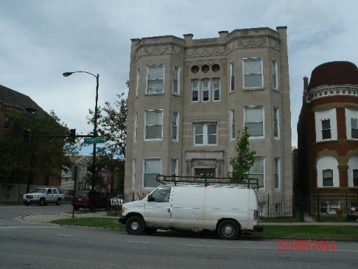 Front view of a multi-story building with decorative facade.