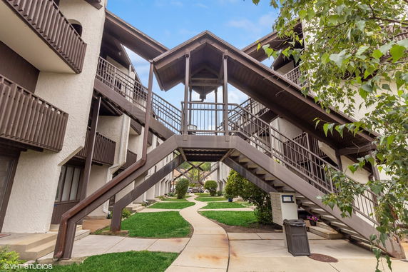 Front view of a multi-story building with external staircases and balconies.