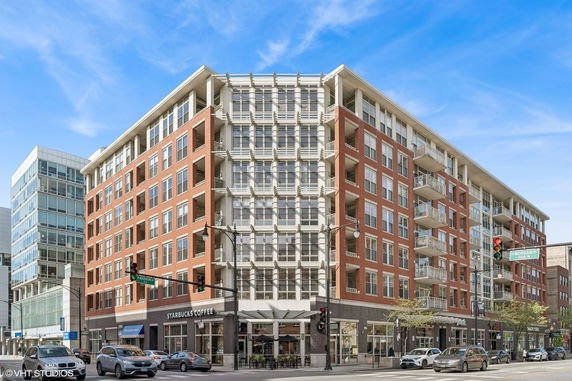 Front view of a multi-story building with a ground-floor retail space.