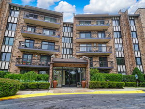 Front view of a multi-story residential building with balconies.