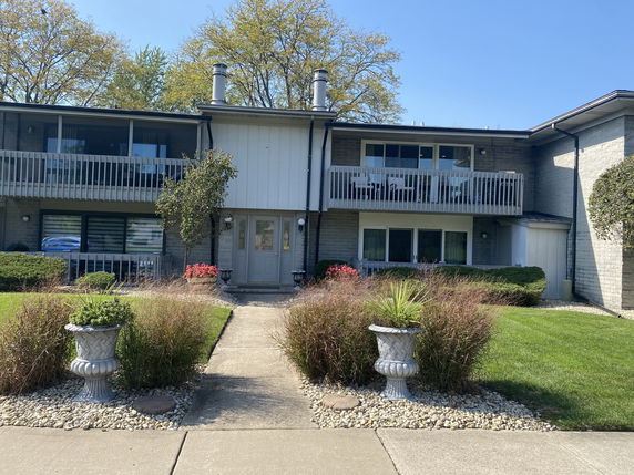 Front view of a two-story residential building with balconies.