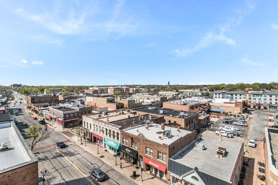 Panoramic view of a downtown area with several commercial buildings and a clear sky.