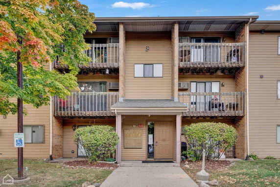 Front view of a three-story building with balconies.