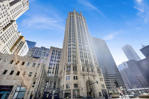 Front view of a tall, ornate skyscraper with gothic architectural details.