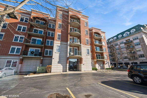 Front view of a multi-story apartment building with balconies.