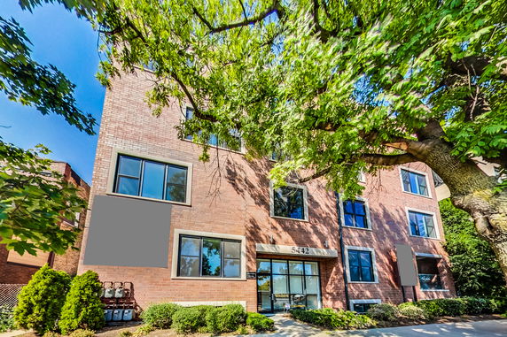 Front view of a multi-story brick apartment building.