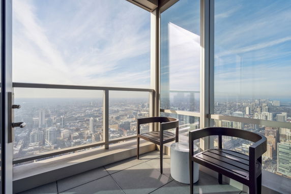 Panoramic view of a cityscape from a high-rise building balcony.
