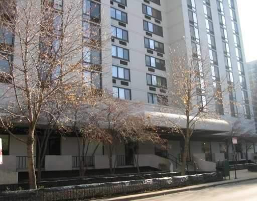Front view of a multi-story building with many windows.