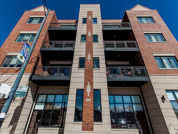 Front view of a multi-story brick apartment building.