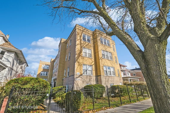Front view of a multi-story brick apartment building.