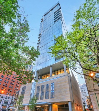 Front view of a modern multi-story glass building.