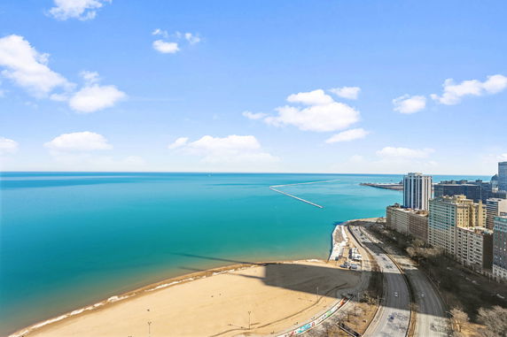 Wide angle view of a body of water and adjacent urban buildings.