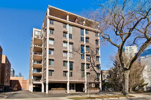Front view of a multi-story apartment building with balconies.