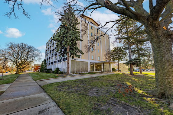 Front view of a multi-story building with a glass entrance.
