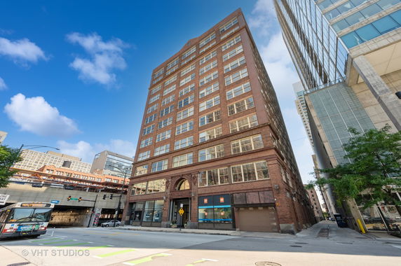 Front view of a multi-story brick building in an urban area.