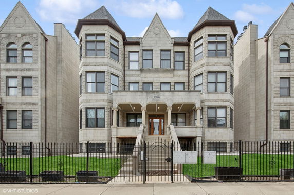 Front view of a multi-story building with a central entrance and symmetrical design.