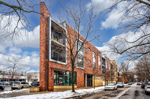 Front view of a modern brick building on a snowy street.