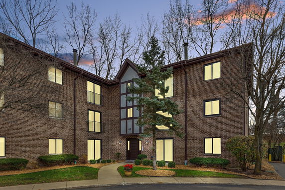 Front view of a multi-story brick building with symmetrical windows.