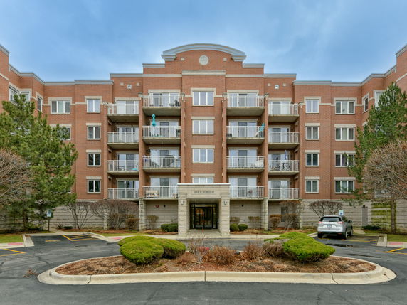 Front view of a multi-story brick apartment building.