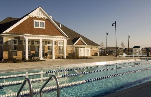 View of a house with a swimming pool in the foreground.