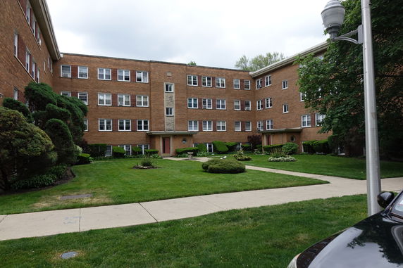 Front view of a multi-story brick apartment building.