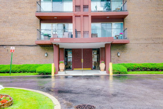 Front view of a multi-story building with balconies.