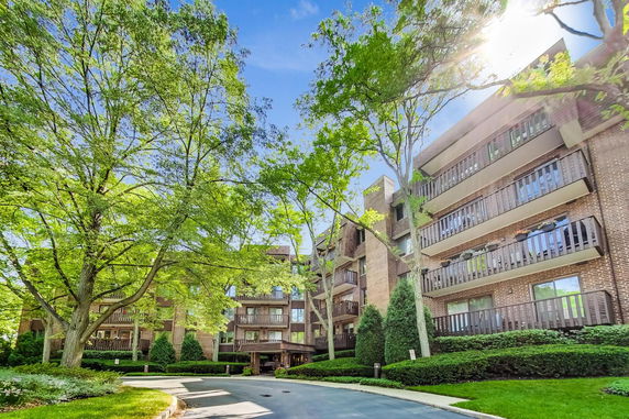 Front view of a multi-story residential building with balconies.