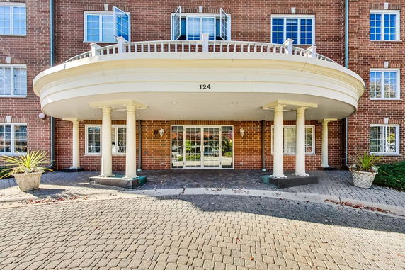 Front view of a building with a curved entrance and columns.