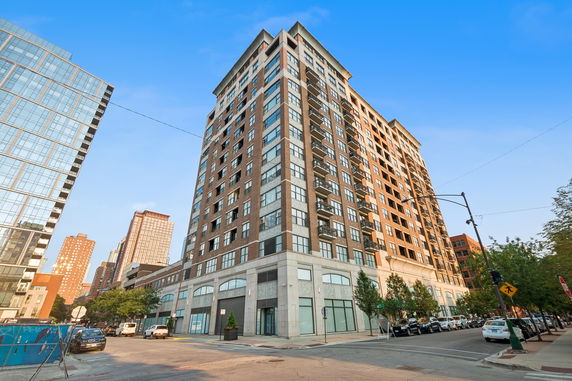 Front view of a multi-story apartment building with balconies.