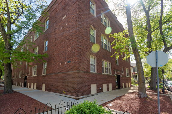 Front view of a three-story brick apartment building.