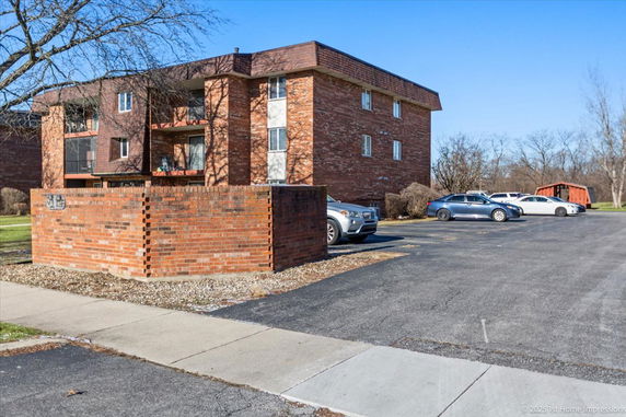 Front view of a multi-story brick building with balconies.