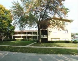 Front view of a multi-story residential building with balconies.