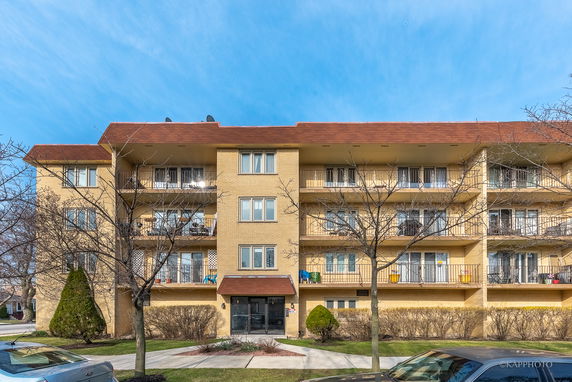 Front view of a multi-story residential building with balconies.
