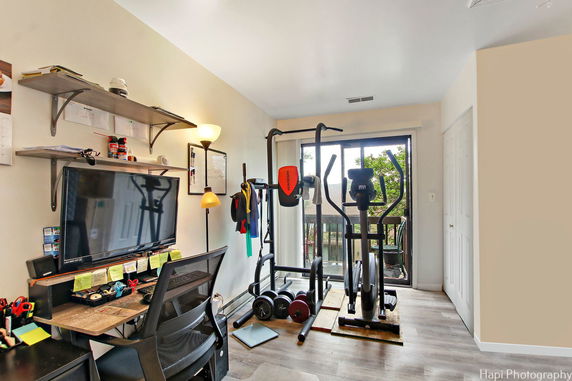 Room setup with exercise equipment and a desk with a computer.