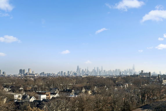 Wide-angle view of a city skyline with skyscrapers in the distance.
