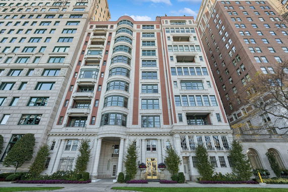 Front view of a multi-story building with large windows and decorative elements.