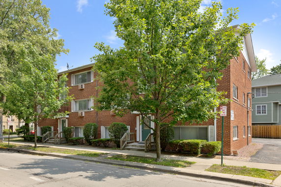 Front view of a three-story brick apartment building.