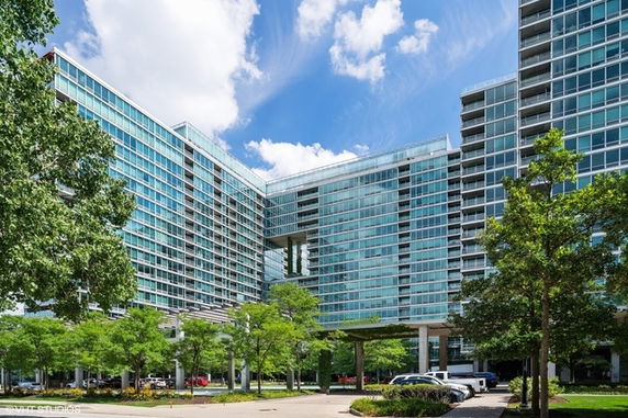 Front view of a modern multi-story building with extensive glass facade.