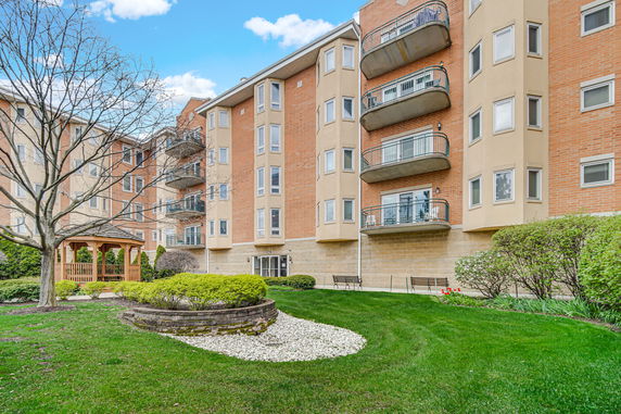 Front view of a multi-story residential building with balconies.