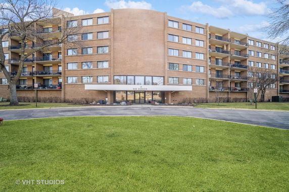 Front view of a multi-story residential building with balconies.