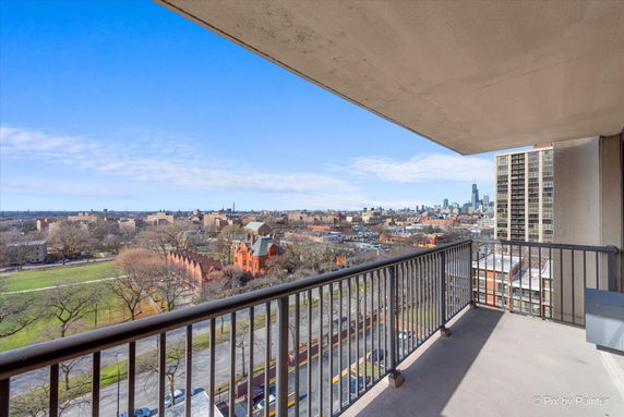 View from balcony showing cityscape and park area.