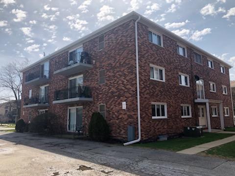 Front view of a three-story brick apartment building.