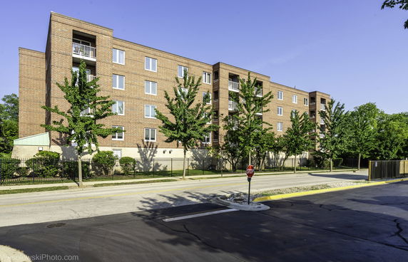 Front view of a multi-story brick apartment building.